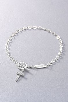 Our Sterling Silver Cross T-Bar Bracelet is a sophisticated and meaningful piece that effortlessly combines elegance with spiritual symbolism. The delicate cross charm serves as a reminder of your faith, while the T-bar closure adds a modern twist to this timeless design. Silver Cross Rosary Bracelet, Silver Cross Bracelet With Adjustable Chain, Nickel-free Silver Cross Rosary Bracelet, Nickel-free Cross Bracelet For Spiritual Style, Nickel-free Sterling Silver Rosary Bracelet