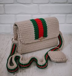 a crocheted purse with a red, green and red stripe on the front