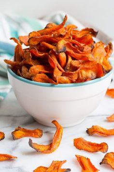 a white bowl filled with sweet potato chips