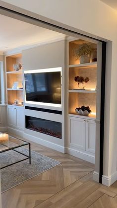 a living room with a fireplace and entertainment center