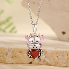 Calves bring joy and warmth to those who encounter them. Their adorable appearance, playful demeanor, and innate innocence make them a cherished part of the animal kingdom. Crafted in sterling silver, this necklace features a shimmering red heart-cut stone hugged by an adorable baby cow. This necklace is a wonderful gift for someone who love nature and the farming life! You will find more adorable and creative designs in our Hug Me® collection.Carat Weight: 1.4 ctStone Size: 6*6 mmStone Type: Je Cow Heart, Farming Life, Dairy Cow, Baby Cow, Dairy Cows, Baby Cows, Love Nature, Hug Me, Necklace Online