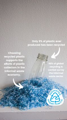 an empty glass bottle sitting on top of a shelf filled with blue carpeted material