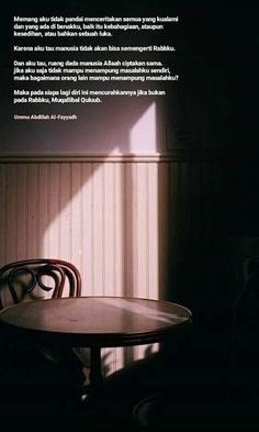 a table with two chairs in front of a wall that has a quote on it