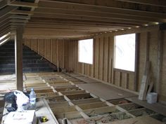 an unfinished room with wood flooring and walls in the process of remodeling