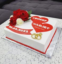 there is a cake with two hearts on it and red roses in the middle that says today, naddif