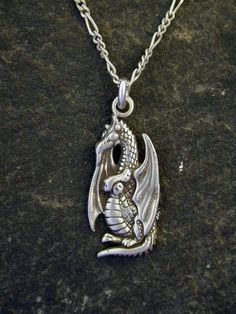 This Dragon  pendant is Sterling Silver. The included chain is a Sterling Silver Figaro 50 chain. You may choose 16, 18 or 20 inch at the same price. Other length available at sightly higher prices. This Dragon pendant measures 1" tall by 1/2" across.  I hand cast all my pieces using the lost wax casting method. Please ask your needs. You may call me with questions, often I am out so please use my machine. 831-476-3176. Satisfaction Guaranteed!I send items USPS First Class unless otherwise direc Symbolic Metal Snake Chain Necklace, Symbolic Snake Chain Necklace, Silver Necklace With 16 Inch Round Pendant, Collectible Silver Charm Necklaces With Lobster Clasp, 16 Inch Snake Chain Jewelry Gift, Symbolic Necklace With Lobster Clasp And Round Pendant, Symbolic Silver Pendant Chain Necklace, Symbolic Silver Necklace With Adjustable Chain, Symbolic Pendant Chain Necklace With Adjustable Chain