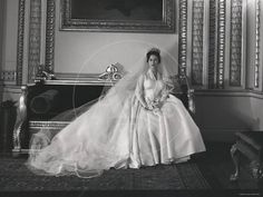 an old black and white photo of a woman in a wedding dress