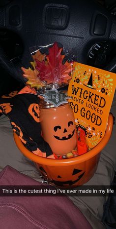 an orange bowl filled with pumpkins and candy