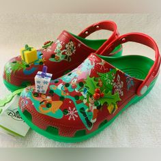 Sale - Disney Parks Christmas Holiday Crocs Classic Clog (Men 6/Women 8). So Cute! These Disney Parks Crocs Are Loaded With Lots Of Your Favorite Disney Characters Getting Ready For The Holidays! This Pair Is A Really Great Christmas Red And Christmas Green And Includes Holiday Embellishments On The Top Side Of The Clogs, Including A Holly Berry Hidden Mickey! These Crocs Will Be A Great Addition To Your Disney Holiday Attire! Me? I’d Wear Them All Year Round! This Pair Is Definitely Unisex And Holiday Attire, Hidden Mickey, Crocs Classic Clogs, Christmas Green, Holly Berry, Women's Crocs, Disney Holiday, Christmas Red, Disney Christmas