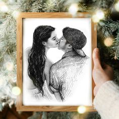 a drawing of two people kissing in front of a christmas tree