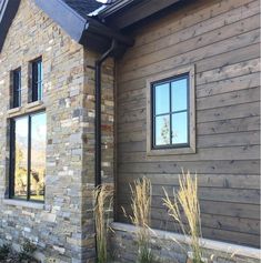 a brick house with two windows on the side