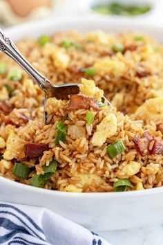 a bowl filled with fried rice and bacon