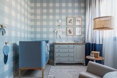 a baby's room is decorated in blue and white checkered wallpapers