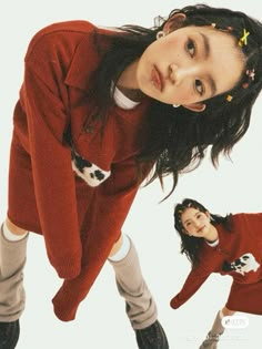 two young women in red sweaters are posing for the camera