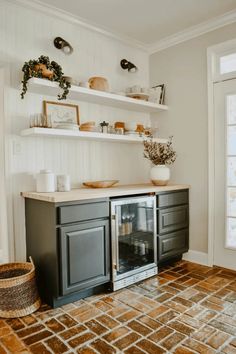 a kitchen with white walls and open shelving