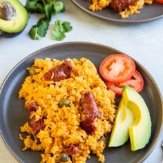 two plates filled with rice and vegetables next to avocado on a white table