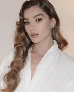 a woman with long hair wearing a white robe