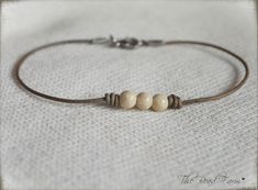 three beads on a leather cord bracelet