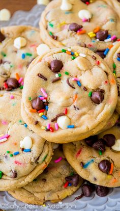 a pile of cookies with sprinkles and chocolate chips