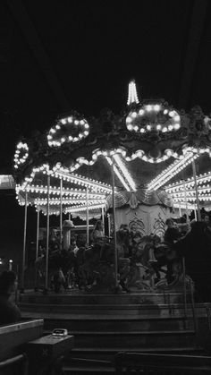 a merry go round at night with people on it