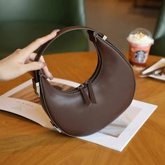 Discover Elegance and Versatility Step into a world of style and sophistication with our Elegant Leather Moon-Shaped Shoulder Bag, designed exclusively for the chic, modern woman. Crafted from high-quality split leather with a sleek polyester lining, this bag showcases a unique half-moon silhouette that is both eye-catching and functional. Whether you're heading to a casual brunch or an elegant evening event, this versatile accessory is your perfect companion. Product Features Type: Shoulder & H Phone Bag Pattern, Underarm Bag, Zipper Bag, Shoulder Messenger Bag, Types Of Bag, Zipper Bags, Luxury Women, Flap Bag, Phone Bag