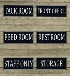 four signs that are on the side of a wooden wall saying,'task room, front office, feed room, restroom, staff only, and storage