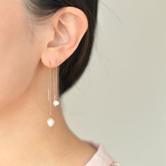 "Dainty Freshwater pearl threader earrings come in two sizes. They are lightweight and easy to put on which makes them suitable for everyday use. They would make the perfect gift idea for bridesmaids on your special day. D E T A I L S - Gorgeous organically shaped freshwater pearls - Lightweight and effortless. Suitable for everyday use - Easy to put on through wire bar ends - A freshwater pearl hanging from a delicate nickel-free chain - Each pearl is unique and irregular in shape by nature and Dainty Pearl Drop Threader Earrings, Dainty Threader Earrings With Pearl Drop, Delicate Pearl Drop Threader Earrings, Long Drop Pearl Earrings With Adjustable Chain For Gift, White Pearl Threader Earrings With Charm, White Pearl Charm Threader Drop Earrings, Rose Gold Pearl Chain Earrings For Wedding, White Pearl Chain Drop Earrings, Delicate White Threader Earrings