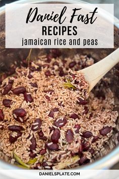 a bowl filled with rice and beans next to a wooden spoon on top of it