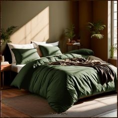 a bed with green comforter and pillows in a room next to a window,