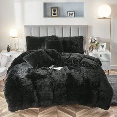 a black comforter set on top of a bed