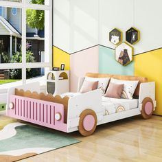 a child's bedroom with a toy car bed in front of a large window