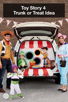 two adults and a child standing in front of a trunk or treat idea car with an image of the characters from toy story 4