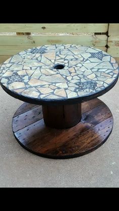 a round table made out of wood and stone