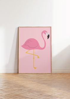 a pink poster with a flamingo standing on it's legs in front of a white wall