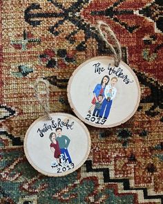 two personalized wedding ornament hanging on a rug