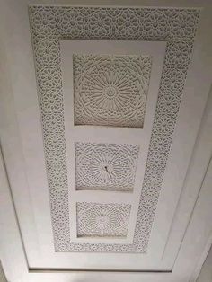 the ceiling is decorated with intricate white paper work and decorative designs on it's walls