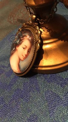 This pendant represents a beautiful French 18th century noblewoman. The pendant is approx. 2,2 x1,6 inch (5,5 x 4 cm) and is set in a leadfree antique brass setting. The necklace is a leadfree antique brass metal chain (length approx. 42cm). Due to the shape of the glass cabochon the light is reflected, so the real pendant is much more beautiful than the picture. The pendant is delivered in a nice gift pouch. Please feel free to follow me on instagram and Pinterest! Handmade Victorian Brooches As Gifts, Handmade Victorian Brooches For Gift, Gold Brooch With Large Pendant As Gift, Antique Oval Necklace With Brooch, Antique Cameo Brooches As Gift, Antique Cameo Brooches For Gift, Antique Brooches With Vintage Charm As Gift, Round Cameo Brooch As Gift, Antique Brooches With Vintage Charm For Gifts