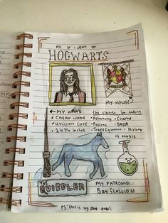 a notebook with some drawings on it and writing about hogwart's in the bottom right corner