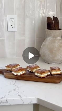 some food is sitting on top of a cutting board in the middle of a kitchen