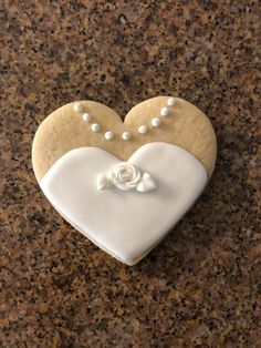 a heart shaped cookie with pearls on it