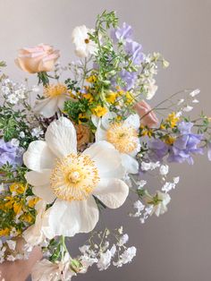 a vase filled with lots of different types of flowers