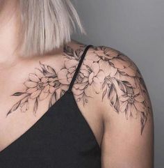 a woman's shoulder with flowers on it