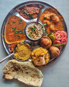 a metal plate topped with different types of food