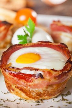 bacon and egg cups on a white plate