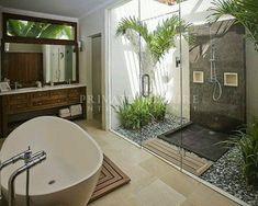 a bathroom with a tub, shower and plants in the bathtub is seen here