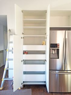 a kitchen with stainless steel appliances and white shelving in the wall next to a refrigerator