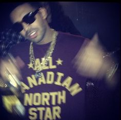 a man in sunglasses and a t - shirt with the words north star on it