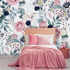 a bedroom with floral wallpaper and pink bedding