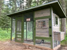 a chicken coop in the middle of a forest