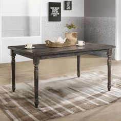 a wooden table sitting on top of a hard wood floor next to a white door